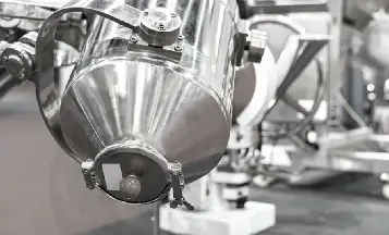 Process engineer reviewing a pharmaceutical powder mixing system
